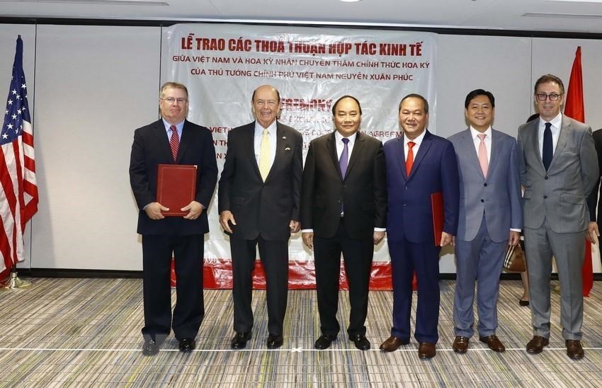 Prime Minister Nguyen Xuan Phuc and US Secretary of Commerce Wilbur Ross witness the handover of documents on trade and investment cooperation during the former’s official visit to the United States from May 29-31, 2017 (Photo: VNA)