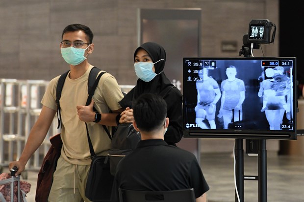 Singapore charges foreigners with COVID-19 for treatment