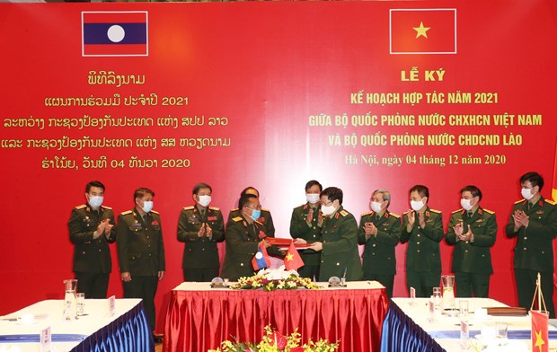 Vietnamese, Lao defence ministries ink cooperation plan for 2021 hinh anh 1