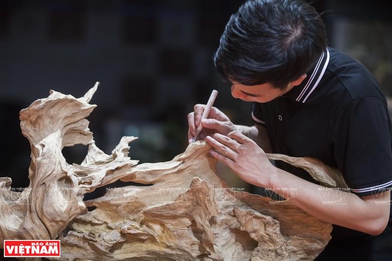 Tu uses different materials, notably wood, to make sculpture (Photo: VNA)
