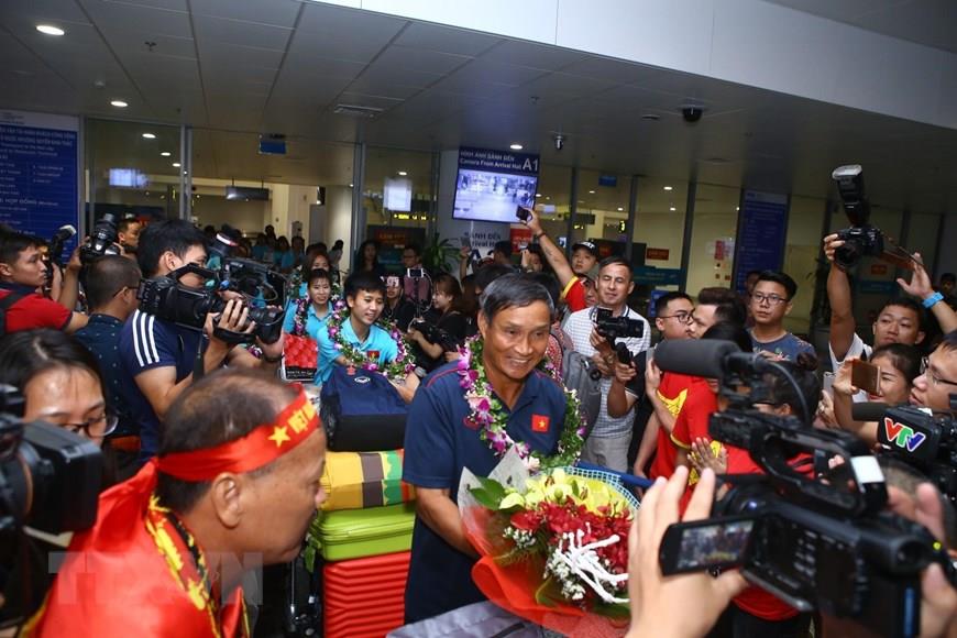 Football fans welcome the national women's football team at Noi Bai International Airport (Photo:VNA)