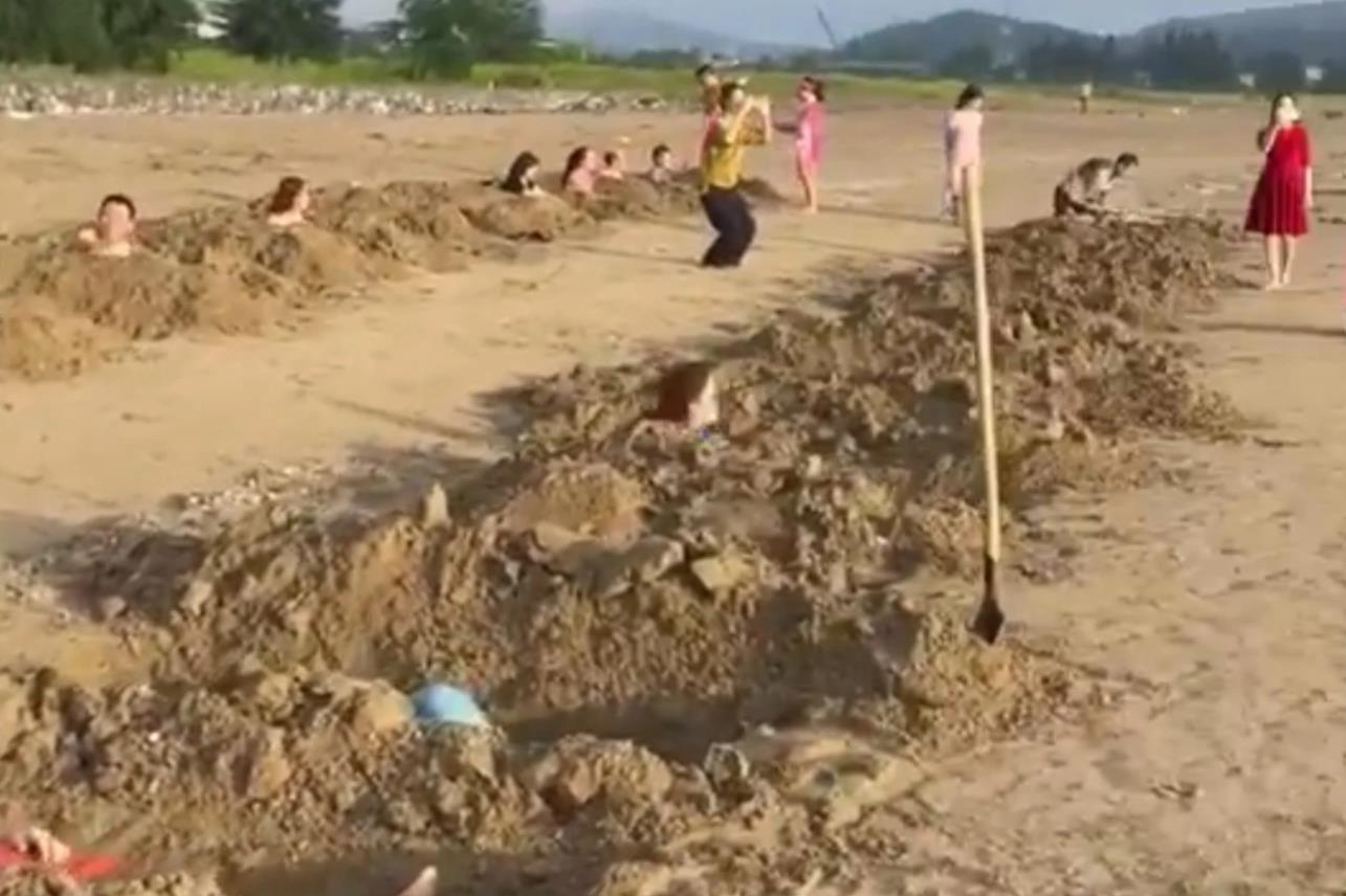 Xôn xao nhóm du khách đào hàng chục huyệt mộ rồi nằm xuống để... tắm cát - 1