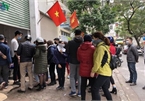 People queue up to buy medical masks at standard price