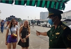 Tourists receive medical examination and masks upon arrival at Saigon port