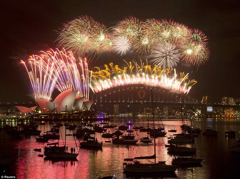 And we're off: An estimated 1.6million people gathered on the shores of the Sydney Harbour for the midnight fireworks show