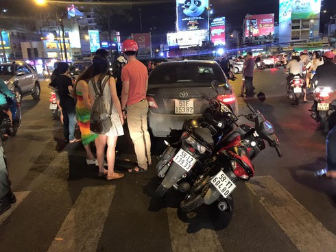 Lùi xe bất cẩn, 2 xe máy bị cuốn vào gầm ô tô Camry ở vòng xoay Dân Chủ - ảnh 1