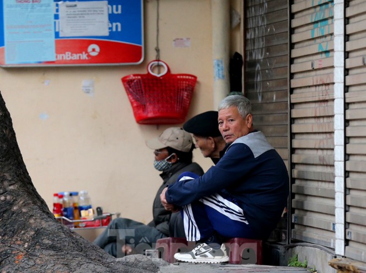 A man drinks a hot cup of tea during the winter’s first cold spell.