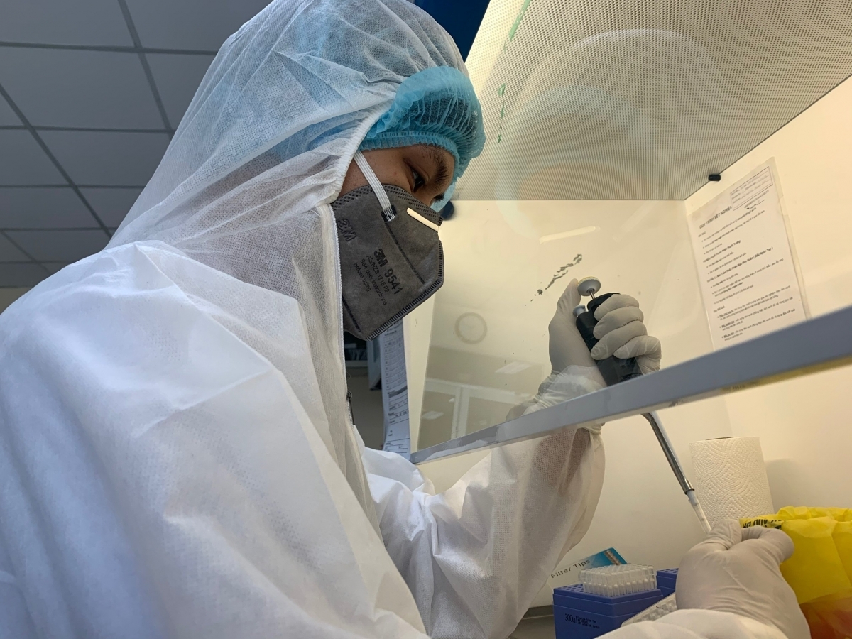 A healthcare worker examines COVID-19 testing results in the lab.