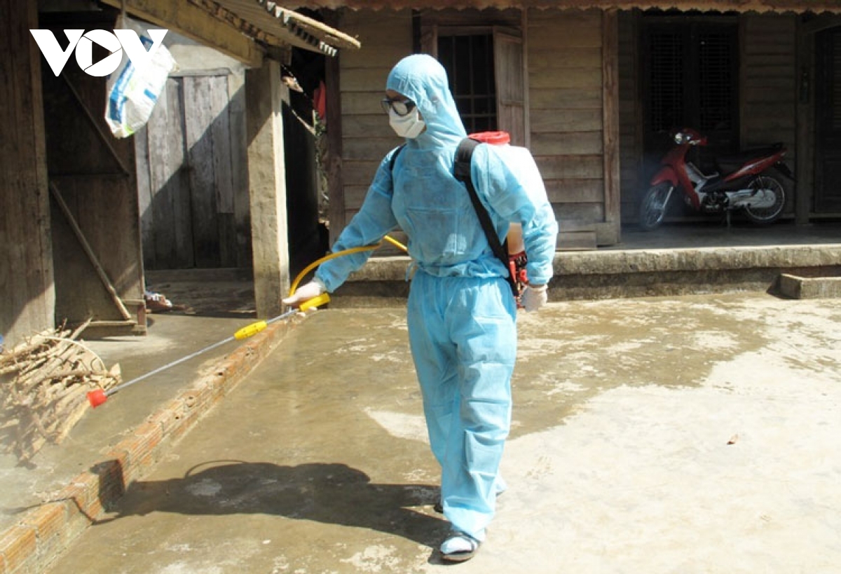 Health worker sprays chemical to kill mosquitoes