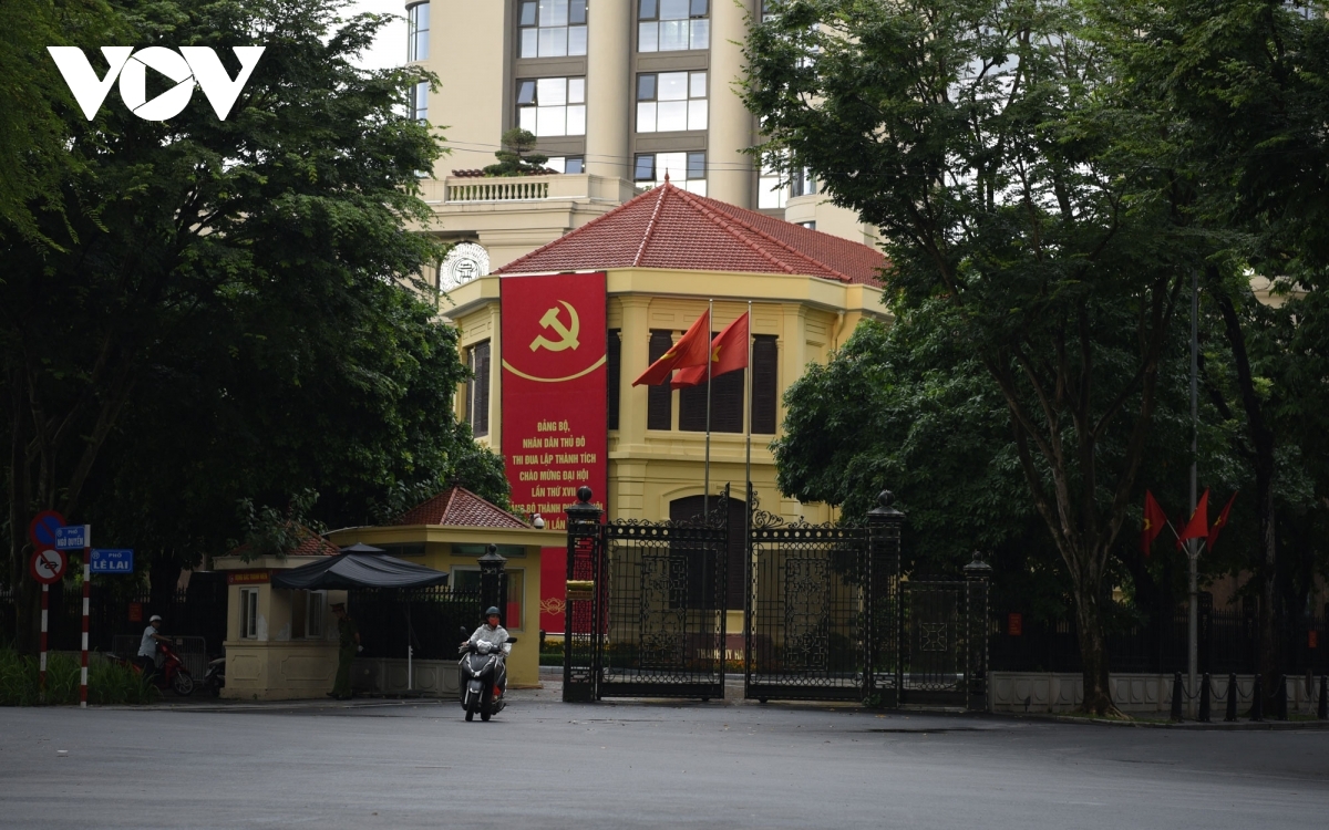 National flags, flowers, and banners are hung out of office buildings as part of efforts to commemorate the ongoing events in the capital.