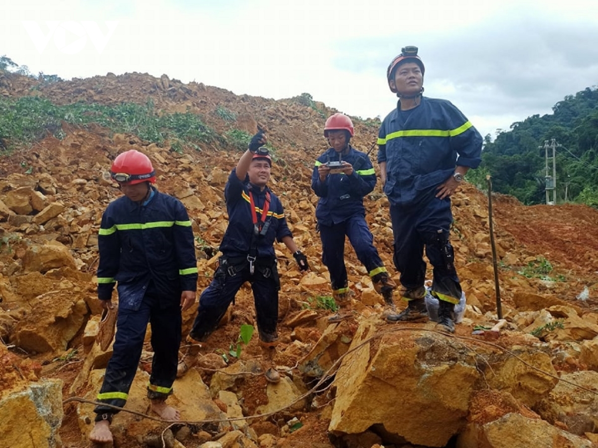 Rescue workers use all equipment available to survey the landslide area where 17 workers have been buried