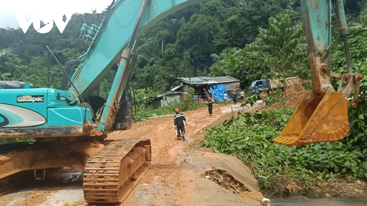 An excavator is used to clear mud that has hit the route leading towards the site