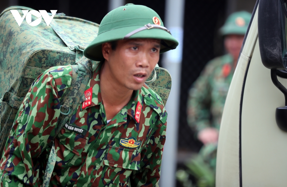 Telecommunications equipment is transferred by soliders to small vehicles in an effort to establish an information network that can boost connectivity among rescue forces