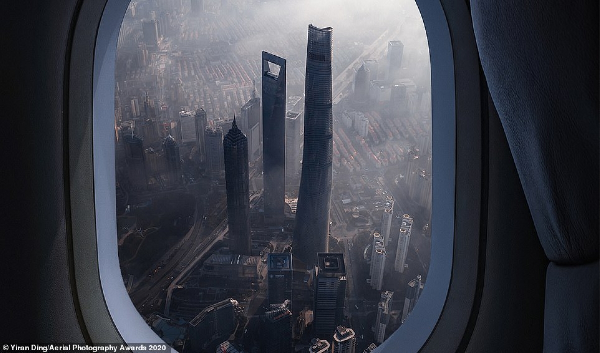 Chinese photographer Yiran Ding claims first prize in the Travel category for his photo of Shanghai as seen through an airplane window.