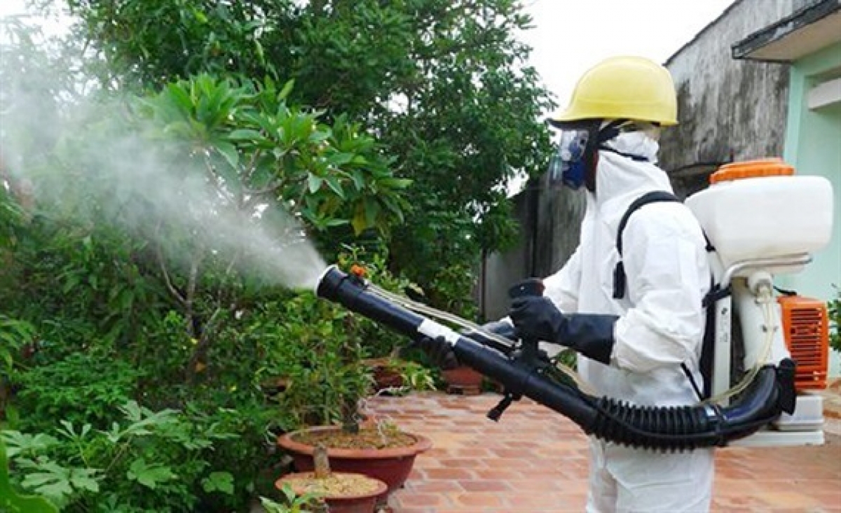 Medical worker is spraying chemicals in a bid to further halt the spread of the disease.