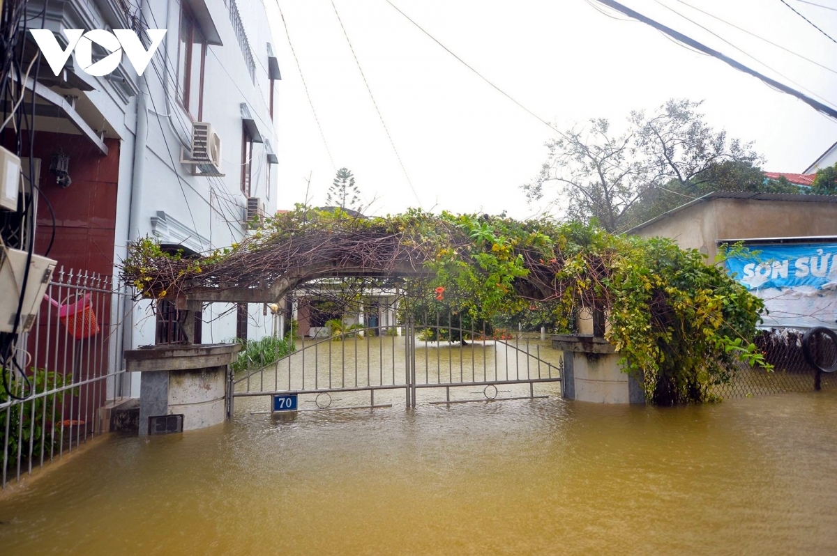 A gate to a house sits one metre deep in water.
