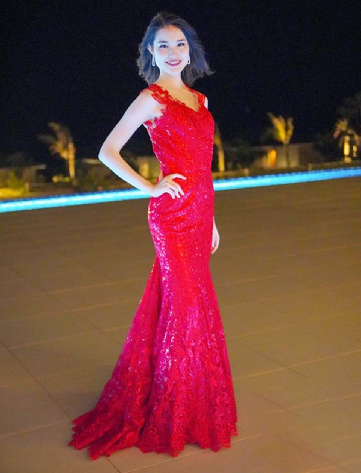 Japanese beauty Anna Tode, 20, shines whilst wearing a red evening gown.
