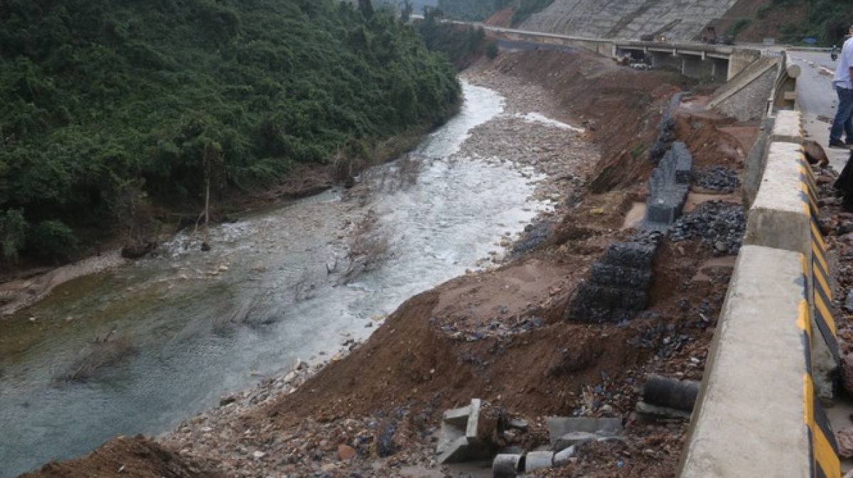 Flood water erodes local roads in central Vietnam, leading to the high risk of landslides.